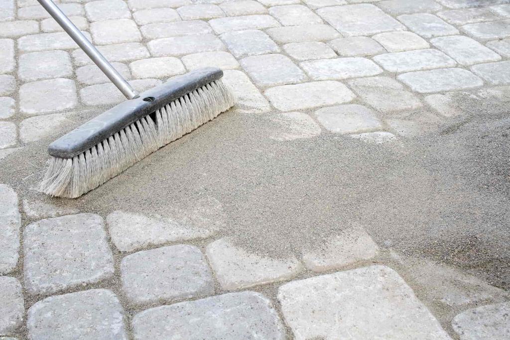 permeable paver patio - sweeping sand into joints - Buddha Builders